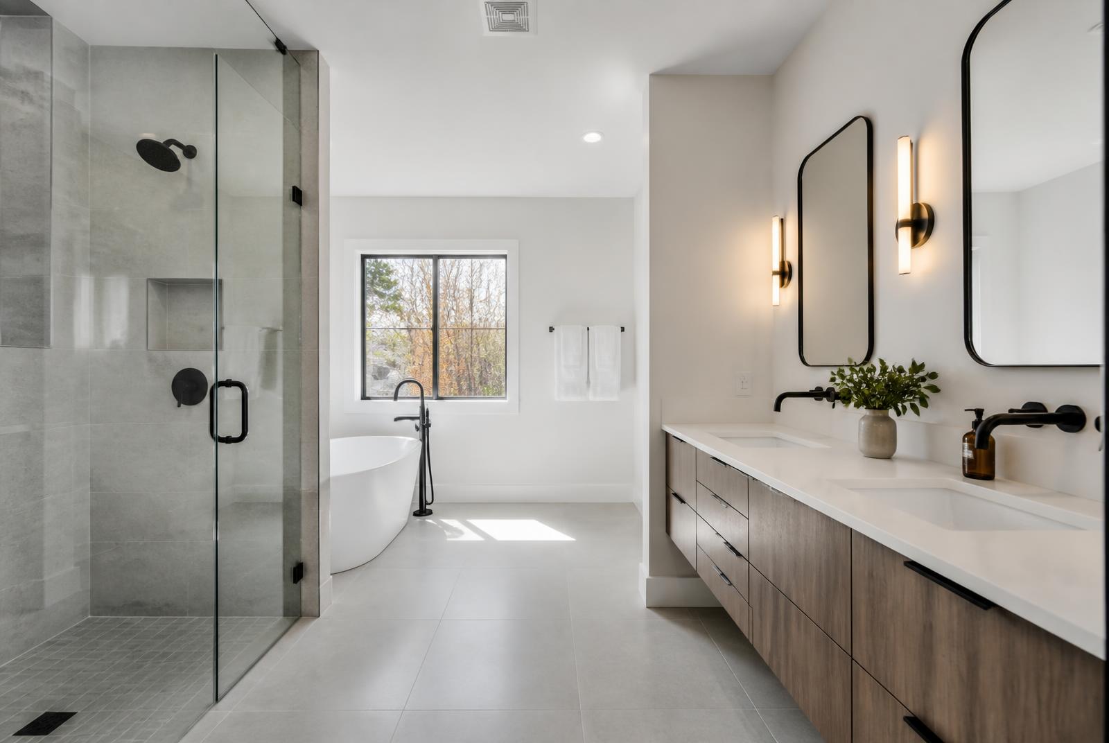 Renovated Florida bathroom with frameless glass walk-in shower, freestanding tub and floating double vanity